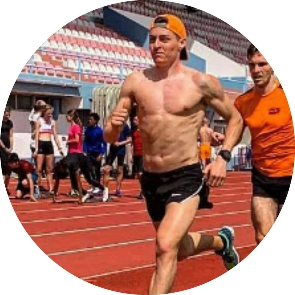 Two athletes training on outdoor running track